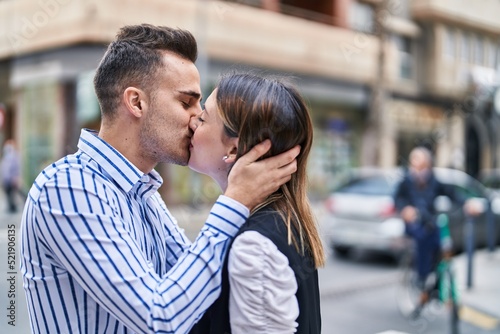 Man and woman couple hugging each other kissing at street © Krakenimages.com