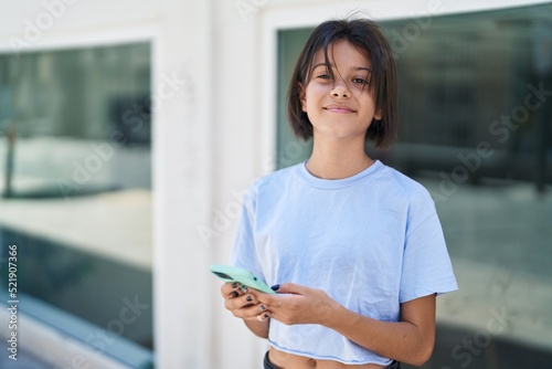 Photographie Adorable hispanic girl smiling confident using smartphone at street