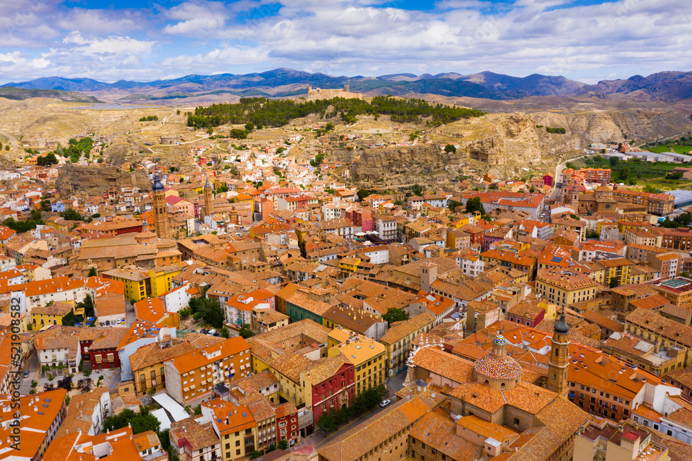 Picturesque aerial view of summer Calatayud cityscape with mountain range of Sierra de Vicort in background, Spain