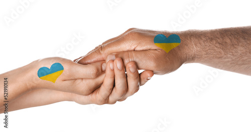 Help for Ukraine. People holding hands with drawings of Ukrainian flag on white background