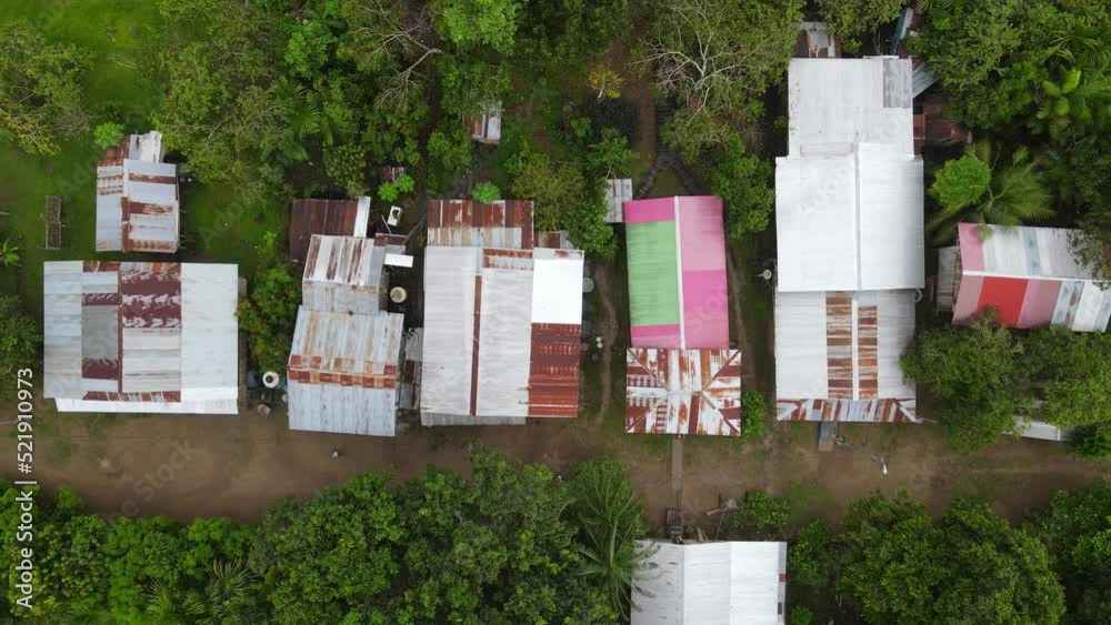 Birds eye view ascending shot, scenic view of the roofs of Puerto Narino in the middle of the amazon forest in Colombia. Birds eye view ascending shot, scenic view of the roofs of Puerto Narino in the middle of the amazon forest in Colombia.