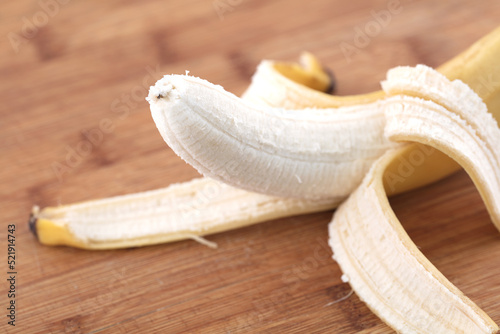 peeled banana on cutting board