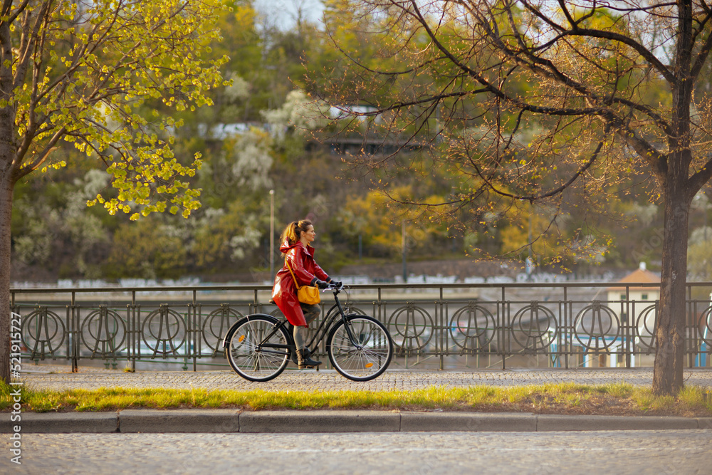 elegant female outdoors on city street riding bicycle
