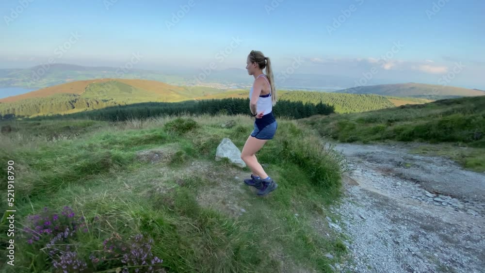 Athletic young woman hiking Ireland's countryside Landscape Athletic young woman hiking Ireland's countryside Landscape