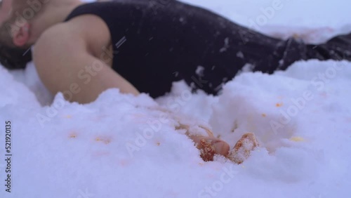 An injured hand sunk into the abdomen.
The struggle for survival in the cold winter season. Freezing to death in the cold.
