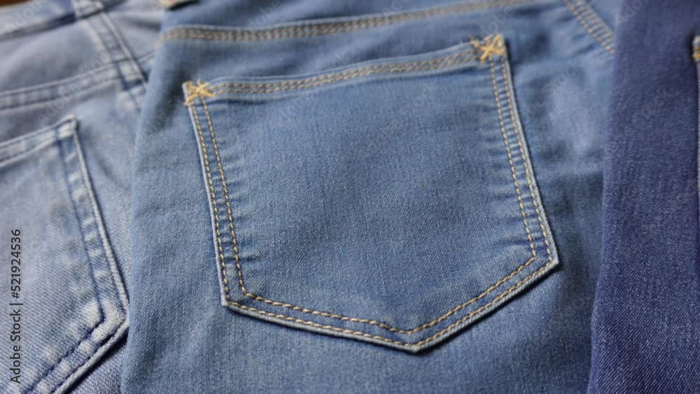 Close up shot of different shades of blue denim jeans back pockets. Close up shot of different shades of blue denim jeans back pockets.