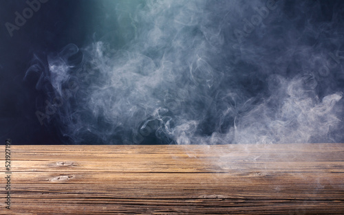 An old brown wooden floor or an empty table with white mist or smoke. on a black background