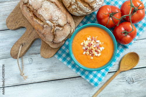 BOWL OF SALMOREJO CREAM, BREADS AND TOMATOES. TYPICAL SPANISH FOOD FROM CORDOBA. TOP VIEW. photo