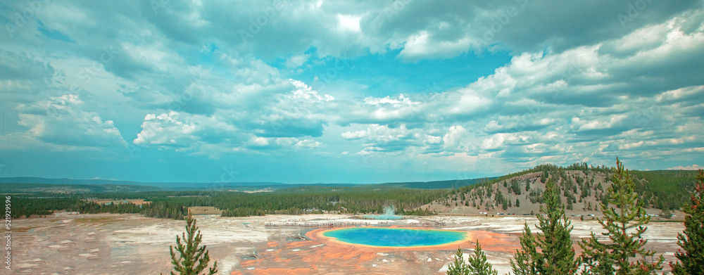 Grand Prismatic hot spring under blue cloudy sky in Yellowstone National Park in the United States