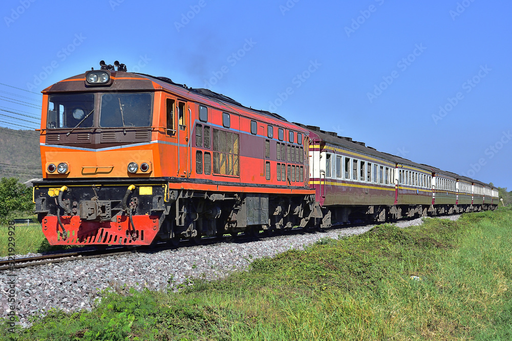 Passenger train by diesel locomotive on the railway in Thailand Passenger train by diesel locomotive on the railway in Thailand