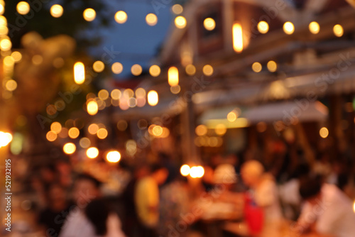 blurred image at the restaurant night time, many people in the restaurant eat and party happy relaxing