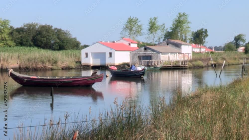 Ria de Ovar in its great natural beauty, with two traditional fishing boats, built in wood, with the houses in the background Ria de Ovar in its great natural beauty, with two traditional fishing boats, built in wood, with the houses in the background