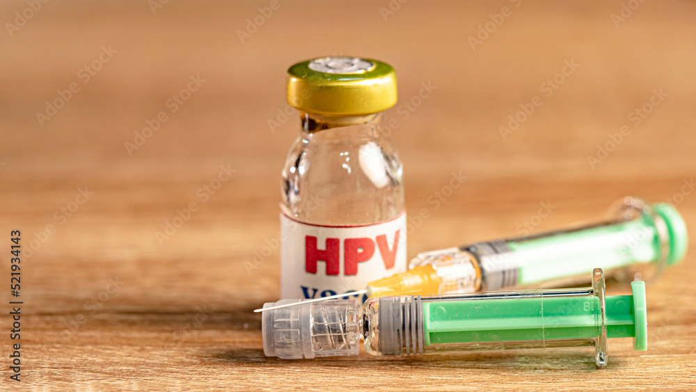 Injection needle with stethoscope and three bottles of vaccines " HPV