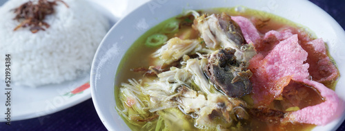 Indonesian chicken soto or soto ayam, served with white rice .panoramic 