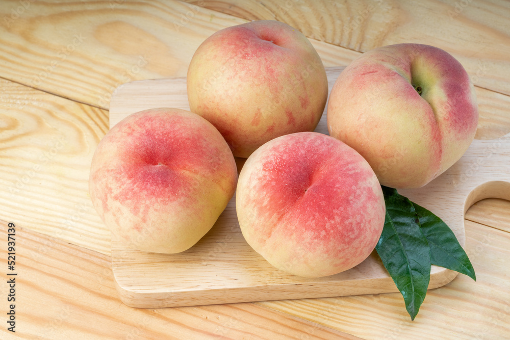 Fresh Sweet Peach on pink wooden background, Pink and yellow Peach fruit with leaf on Wooden table. Fresh Sweet Peach on pink wooden background, Pink and yellow Peach fruit with leaf on Wooden table.