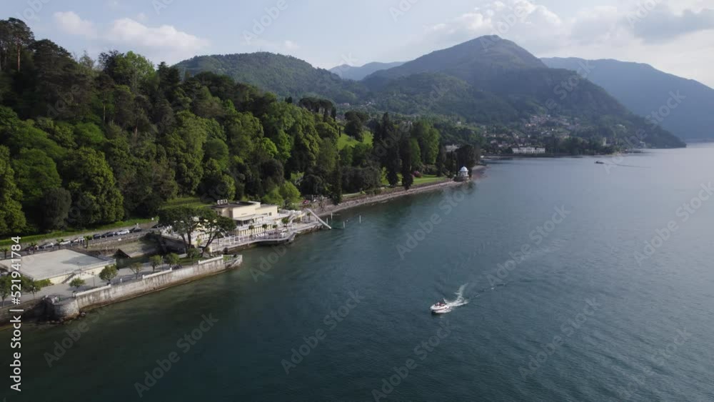 Speedboat Cruising In The Lake Como Passing By The Bistro In Bellagio, Italy. - aerial Speedboat Cruising In The Lake Como Passing By The Bistro In Bellagio, Italy. - aerial