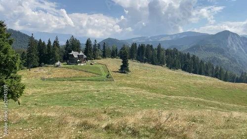 Mountains, valleys and road leading to a small cabin retreat,  beautiful dramatic clouds, sunny mountain landscape , travel and tourism, Dealul Sasului, Rucar Bran, Romania photo