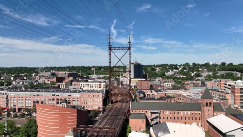 An aerial view of the Norwalk River Railroad Bridge on a sunny morning. The drone camera dolly out from one electrical tower to the next and pan left. photo