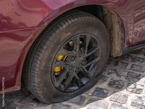 Close-up of a flat tire on a car. Problems on the road. © Konstantin divelook