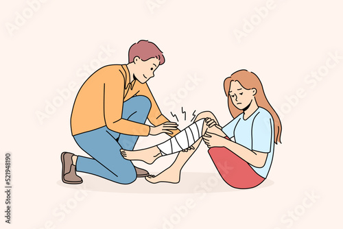 Man give first aid to hurt girl with leg injury. Male volunteer help little child broke leg outdoors, put bandage. Vector illustration. 