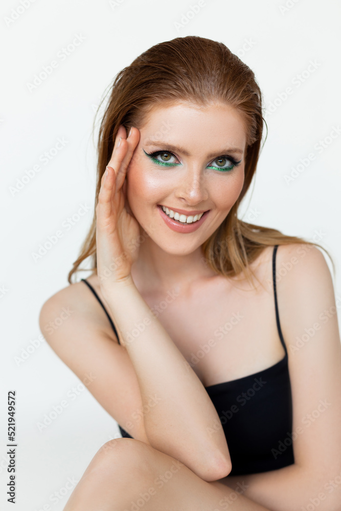 Portrait closeup of flirting woman with bright evening makeup and highlighting expressive eyes on white background. Advertising shooting, cosmetic brand. Professional makeup and beauty products Portrait closeup of flirting woman with bright evening makeup and highlighting expressive eyes on white background. Advertising shooting, cosmetic brand. Professional makeup and beauty products