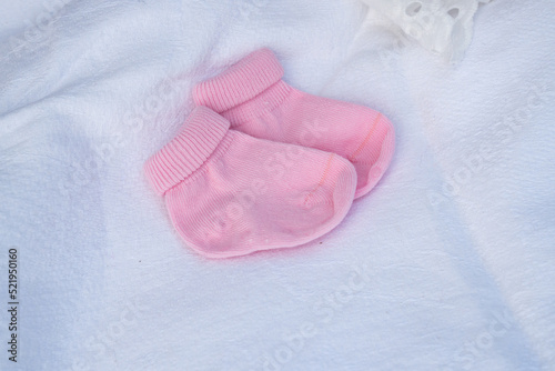 Pink socks for a newborn on a white background