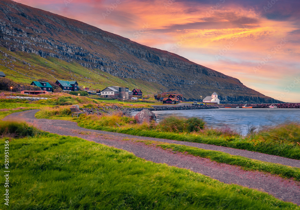 Fototapeta premium Windy summer view of Hestur Island. Splendid morning scene of Kirkjubour village with old country road, Faroe Islands, Kingdom of Denmark, Europe. Traveling concept background.