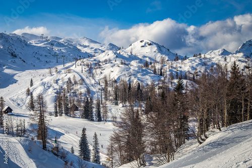 Bohinj, Slovenia - Vogel ski resort in Bohinj in Julian Alps on a sunny winter day with blue sky and clouds