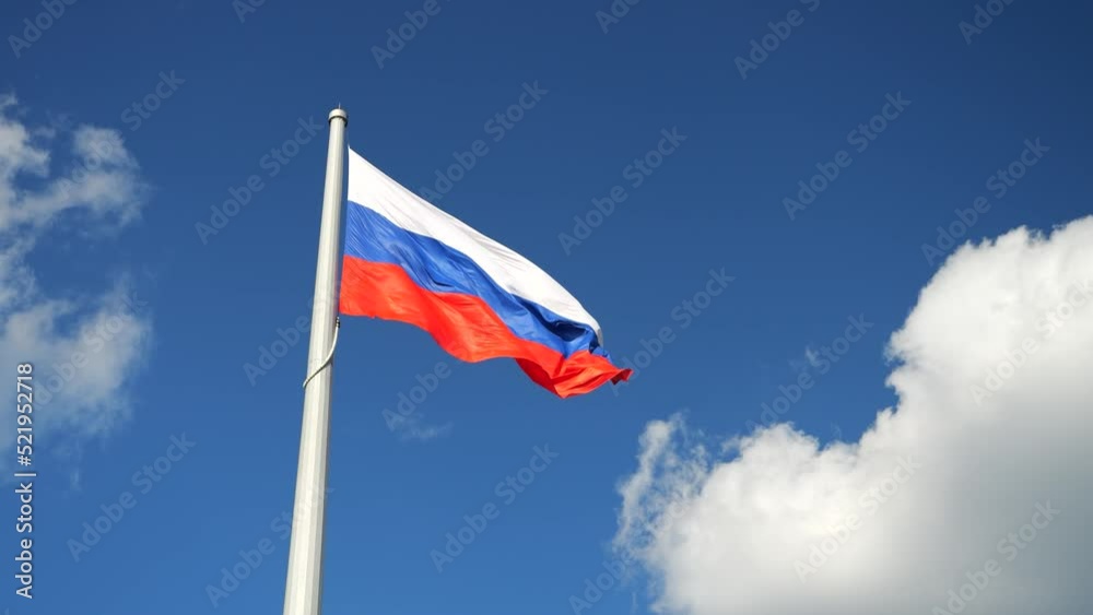 the flag of russia against the background of the blue sky flutters in the wind the flag of russia against the background of the blue sky flutters in the wind