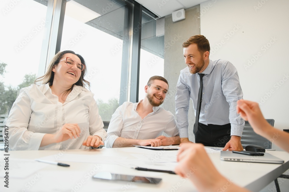 Corporate business team and manager in a meeting room at modern office with panoramic windows. Business concept