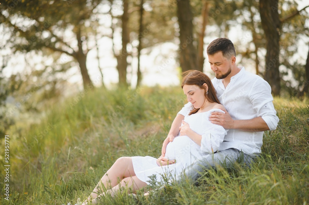 Pregnant woman with her family looking happy Pregnant woman with her family looking happy