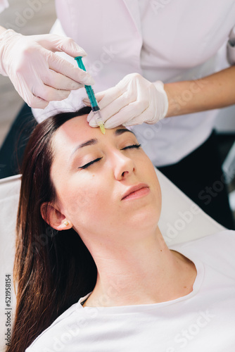 Injectable tissue stimulator on woman face in beauty salon