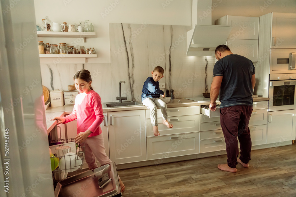 Father with children in kitchen at home Father with children in kitchen at home