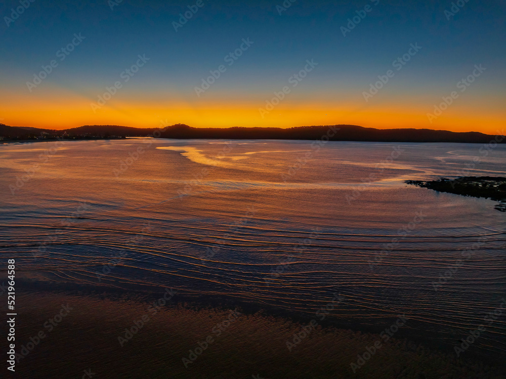 Aerial sunrise seascape with orange glow on a cold Winter's morning