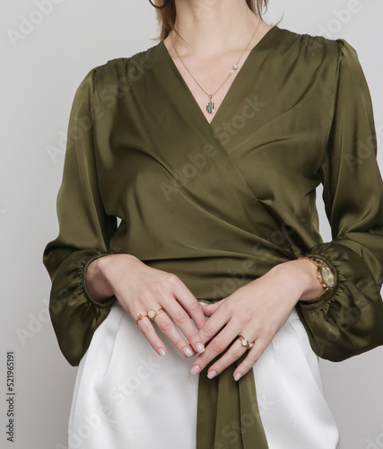 Serie of studio photos of young female model wearing pine green silk satin wrap blouse photo