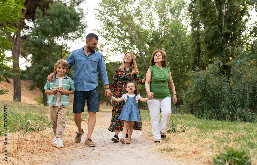 Smiling family walking on dirt road