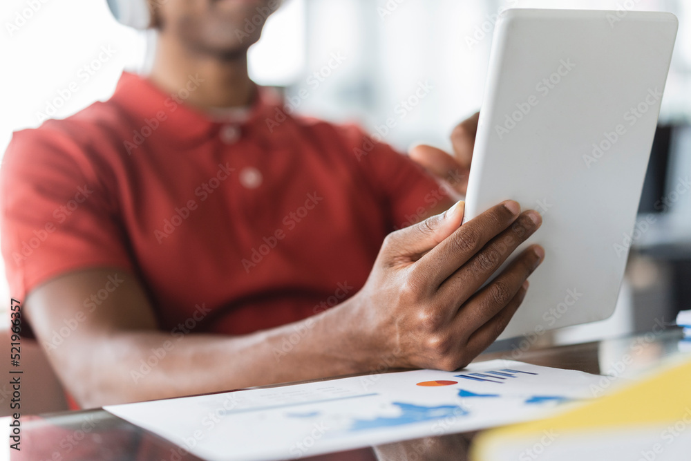 Hands of businessman holding tablet PC at desk in office Hands of businessman holding tablet PC at desk in office