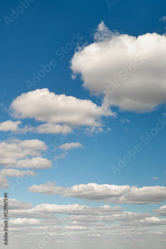 White cumulus clouds in the blue sky. Bright beautiful sky  copy space background
