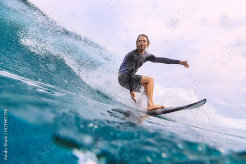 Man with surfboard surfing on sea photo