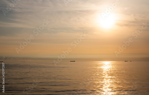Seaside with sunset evening. beautiful horizon sunlight nature background. seascape outdoor with orange cloud sky backdrop. for tourist travel tropical summer holidays or broken heart lonely concept. © wing-wing