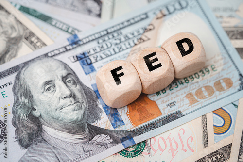 FED wording with up and down arrow on USD dollar banknote for Federal reserve increase and decrease interest rate control which effect to America and world economic growth concept.