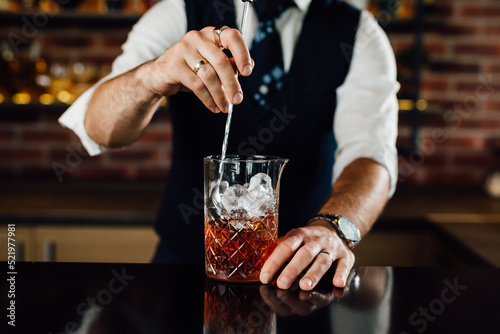 closeup of barman mixing cocktail