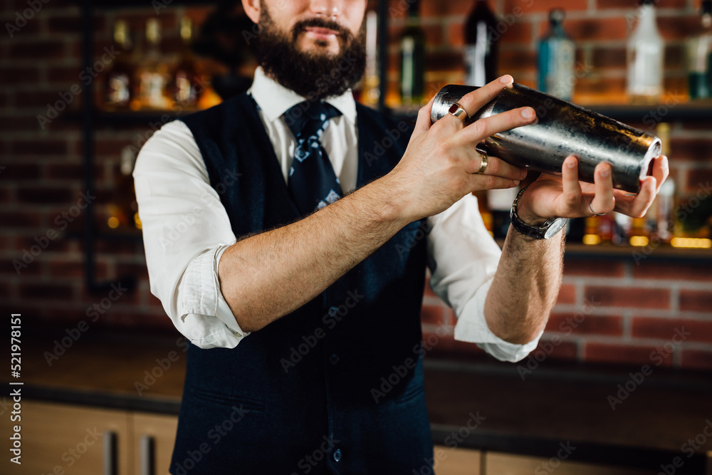 close up of barkeeper shaking cocktail in nightclub close up of barkeeper shaking cocktail in nightclub