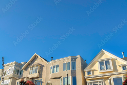 Traditional home along with the taller houses in a low angle view at San Francisco, California