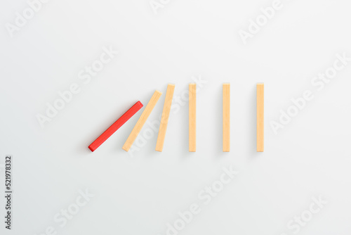 Red wooden domino effect on white background