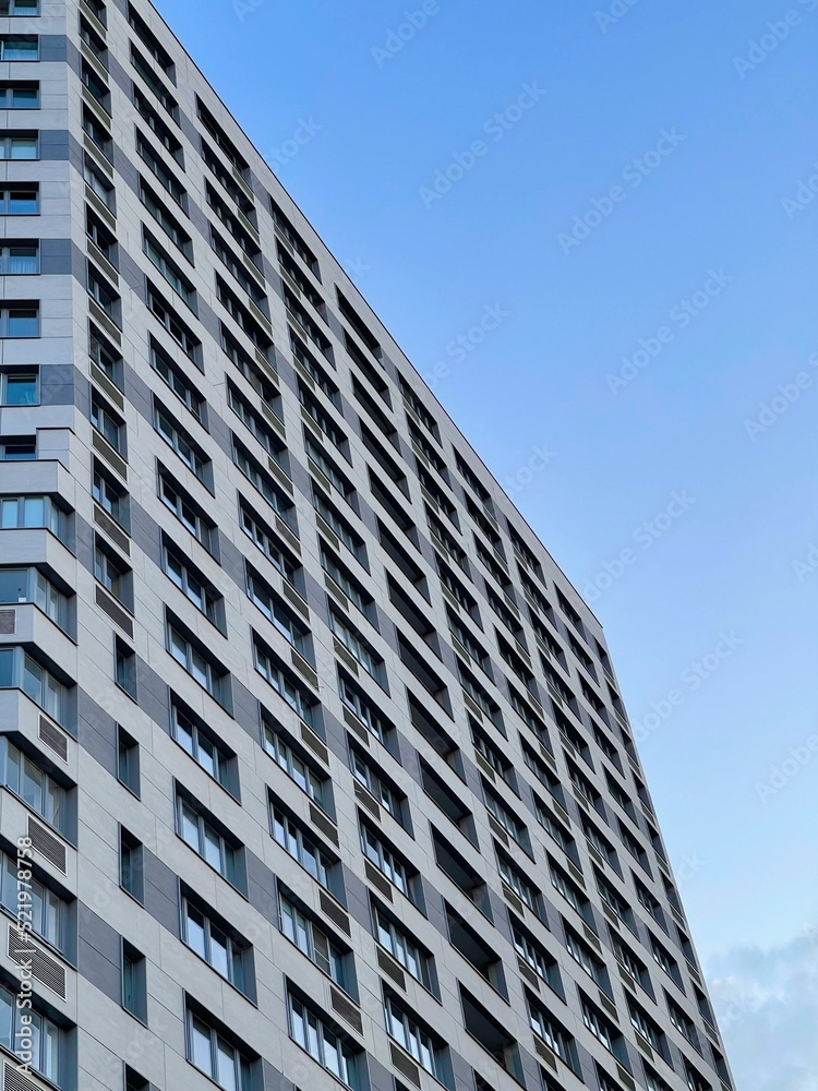 Modern office building on blue sky background