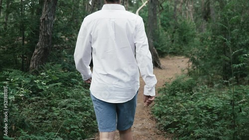 Man walking through the forest in slow motion. photo