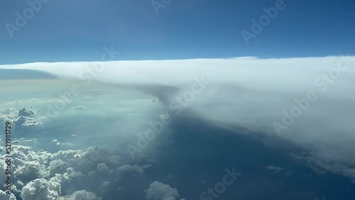 Impressive aerial view from a jet cockpit next to overfly a huge cumulonimbus in a hot summer afternnon. Pilot point of view. 12000 metres high. photo