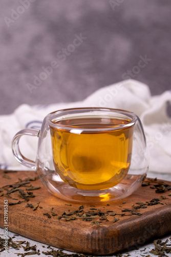 Green tea. Green tea in a wooden serving dish on a stone background. Healthy drinks. Herbal tea concept. close up