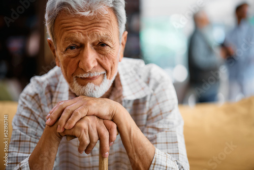 Close up of an old man at nursing home looking at camera. photo